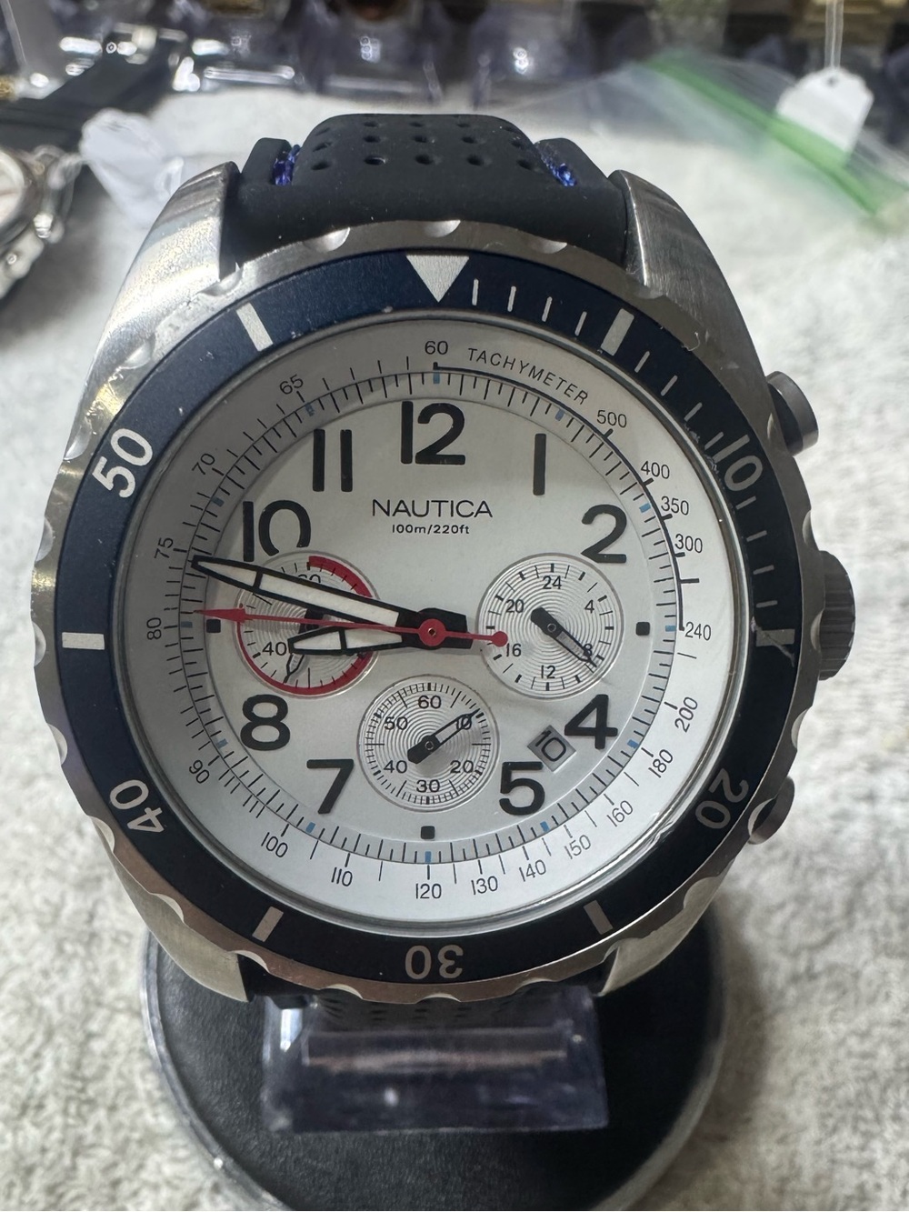 Nautica Silver Case White Dial Watch with Blue Bezel and Red Accents